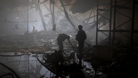 A firefighter stands in the ruins of a printing house in Kharkiv, after a barrage of Russian strikes hit northeastern Ukraine on May 23.