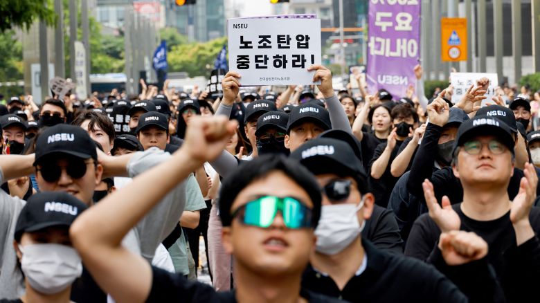 A union holds a placard that says "stop union busting" in front of the Samsung Electronics Seocho Building in Seoul on May 24, 2024.