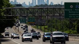 Cars drive along a highway during the Memorial Day weekend while the New York Skyline and the Empire State Building are seen in the background in Clifton, New Jersey, U.S. May 24, 2024.
