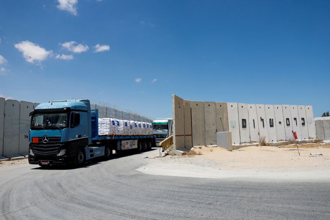 Egyptian trucks carrying humanitarian aid make their way to the Gaza Strip at the Kerem Shalom crossing on May 30, 2024.