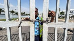 A worker stands by the gate of the domestic airport, which has been chained to prevent passengers from entering the premises, as Nigeria's main labour unions called for an indefinite strike from Monday after failing to agree to a new minimum wage with the government, in Lagos, Nigeria, on  June 3, 2024.