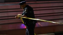 An NYPD officer seals off a crime scene after a shooting left two police officers wounded in the Queens borough of New York City, New York, U.S., June 3, 2024.    REUTERS/Lloyd Mitchell