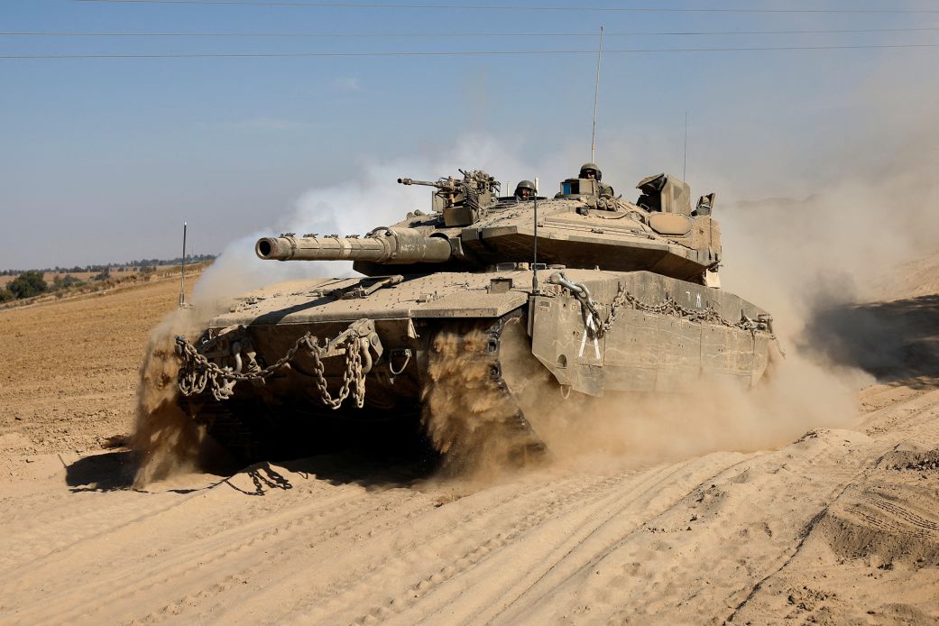 A tank maneuvers near the Israel-Gaza border, as seen from Israel, on June 6, 2024.