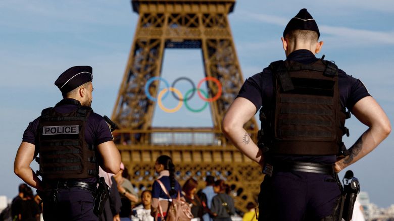 Police officers patrol on the Trocadero square in front of the Olympic rings displayed on the first floor of the Eiffel Tower ahead of the Paris 2024 Olympic games in Paris, France, June 7, 2024. REUTERS/Sarah Meyssonnier