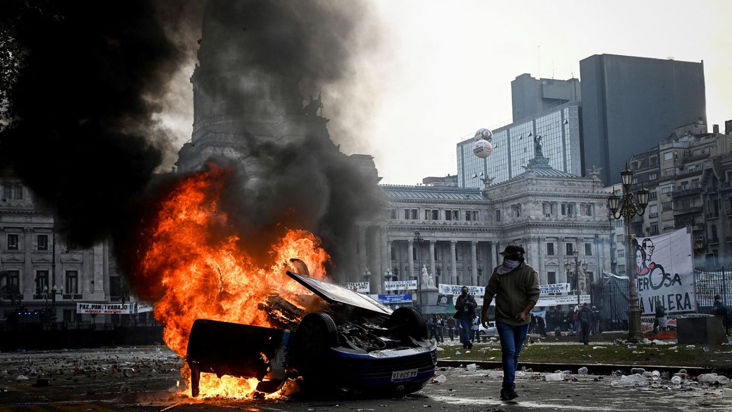 A car burns during a protest near Argentina's National Congress, on the day senators debate President Javier Milei's economic reform bill, in Buenos Aires on June 12.