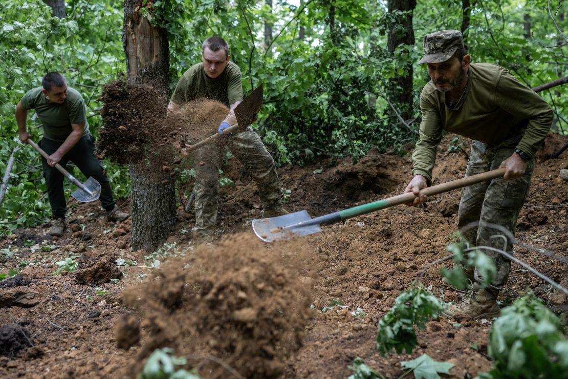 Ukrainian soldiers of the 42nd Separate Mechanized Brigade set up positions on the front line near Vovchansk on June 12, 2024.