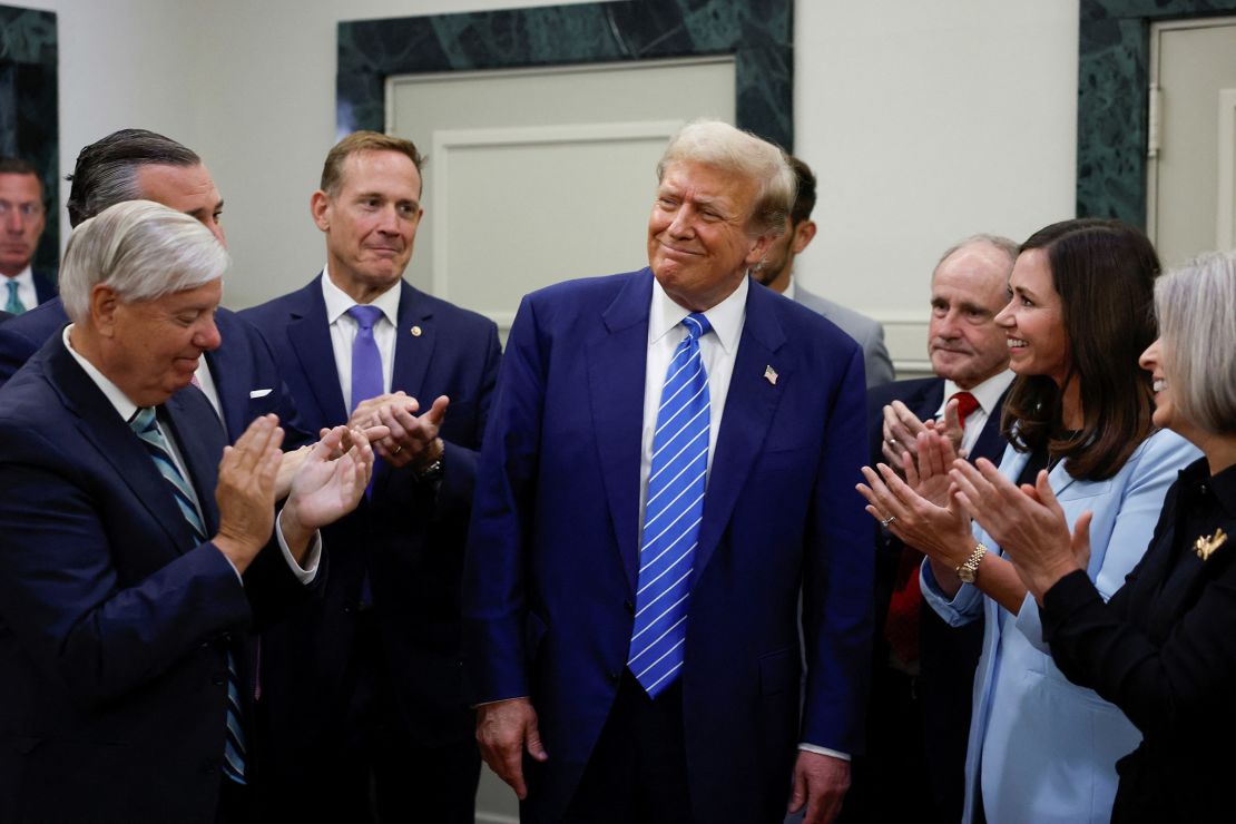 Former President and Republican presidential candidate Donald Trump reacts as he is applauded by Republicans at the National Republican Senatorial Committee headquarters in Washington on June 13, 2024.