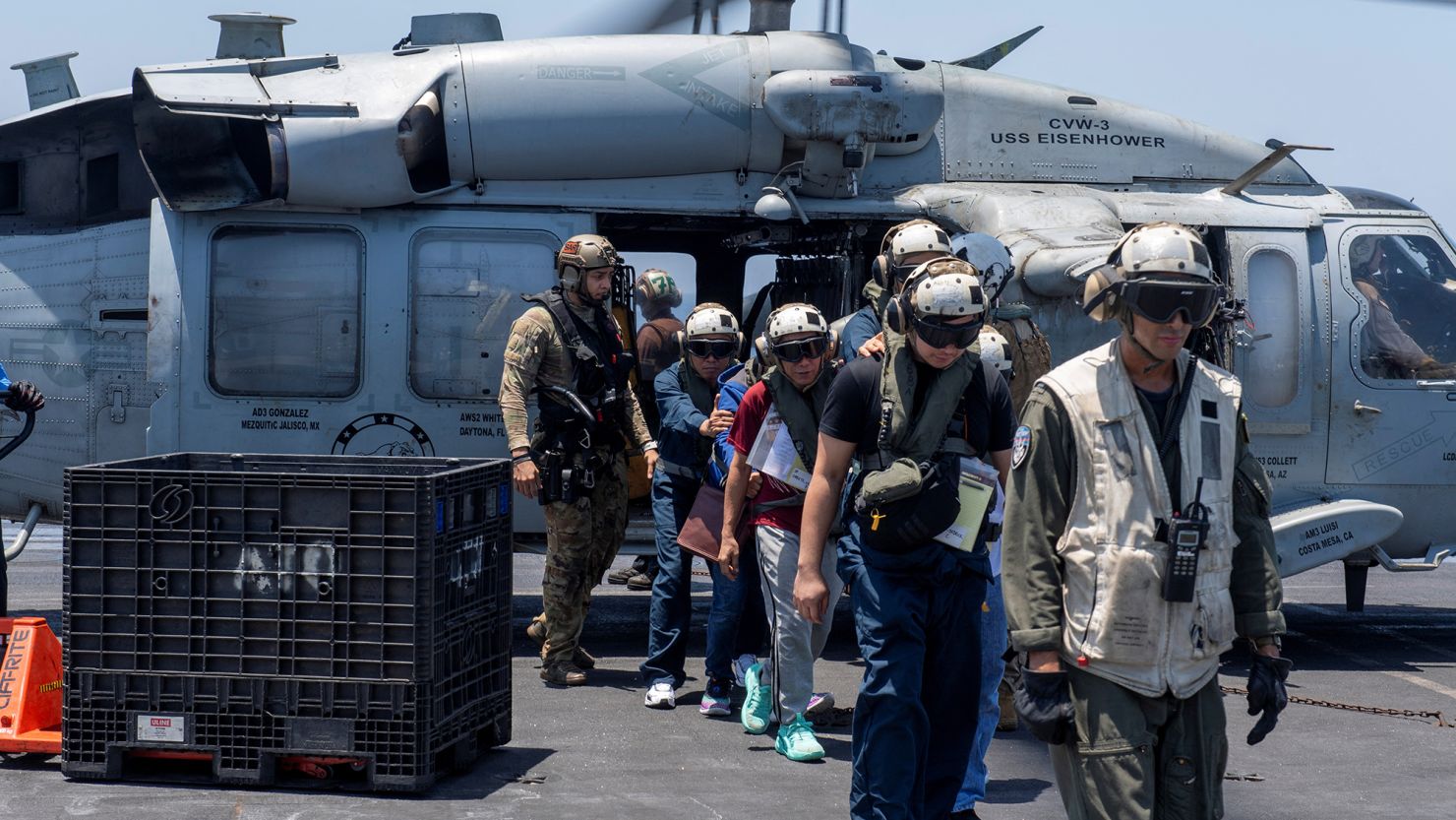 Sailors from the Dwight D. Eisenhower Carrier Strike Group assist mariners rescued from the M/V Tutor, which was attacked by Houthis, in the Red Sea, on June 15.