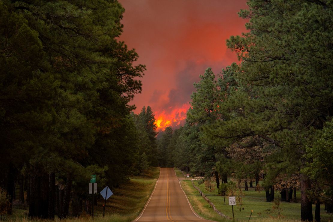 The smoke plume from the South Fork Fire rises above the tree line as the fire spreads from the Mescalero Apache Reservation to the Lincoln National Forest.