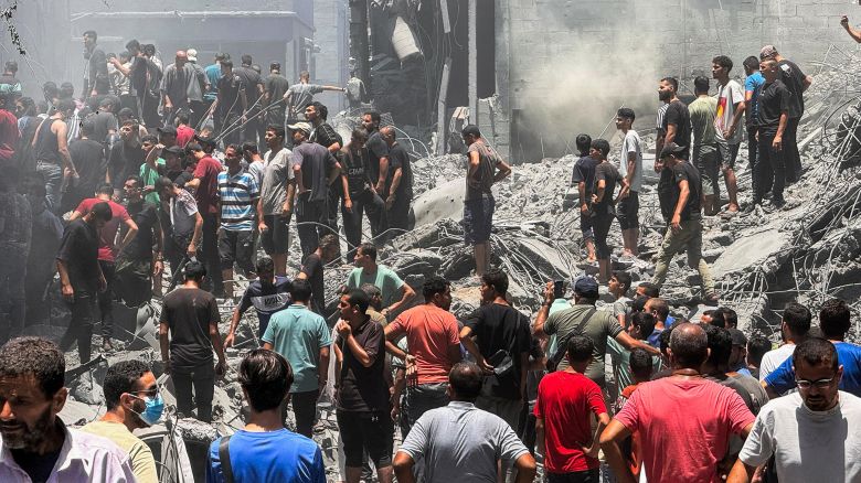 Palestinians search for casualties at the site of Israeli strikes on houses in Gaza City on Saturday.