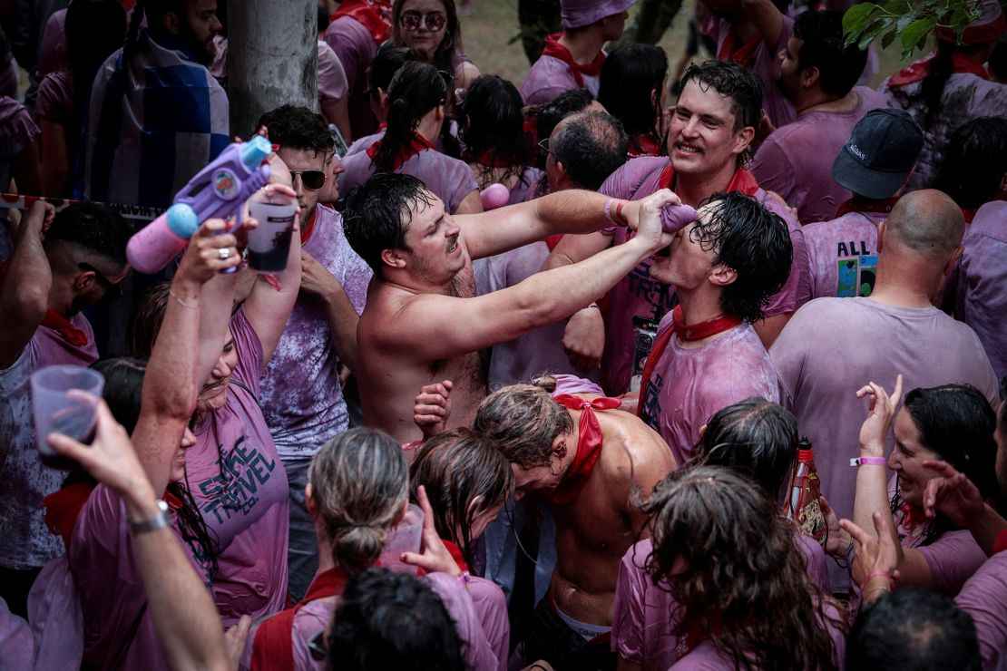 Locals spray and pour around 50,000 liters of wine over each other during the one-day event.