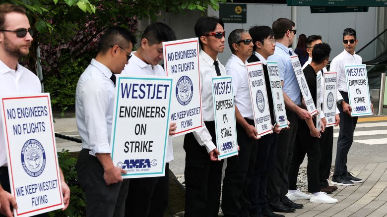 Striking aircraft maintenance engineers and technical staff represented by the Aircraft Mechanics Fraternal Association union stand in a picket line against Westjet Airlines at Vancouver International Airport in Richmond, British Columbia, Canada June 29, 2024.