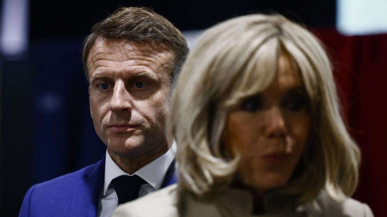 French President Emmanuel Macron and his wife Brigitte Macron visit a polling station to vote in the first round of the early parliamentary elections in Le Touquet-Paris-Plage, on June 30, 2024.
