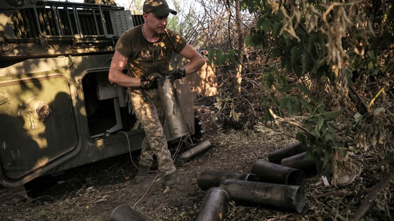 A Ukrainian serviceman removes empty shell cartridges after firing towards Russian troops on the front line near Chasiv Yar on June 30, 2024.