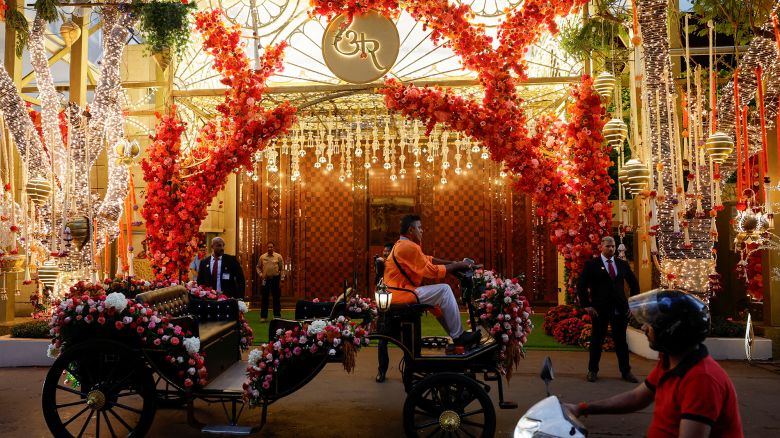 A motorised carriage passes by the decorated gate of Antilia, the Ambani residence, during the pre-wedding ceremony of Anant Ambani and Radhika Merchant, in Mumbai, India, July 3, 2024.