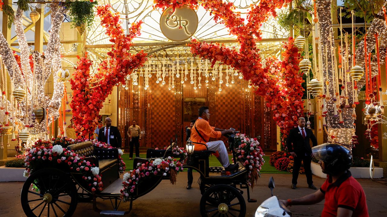A motorised carriage passes by the decorated gate of Antilia, the Ambani residence, during the pre-wedding ceremony of Anant Ambani and Radhika Merchant, in Mumbai, India, July 3, 2024.