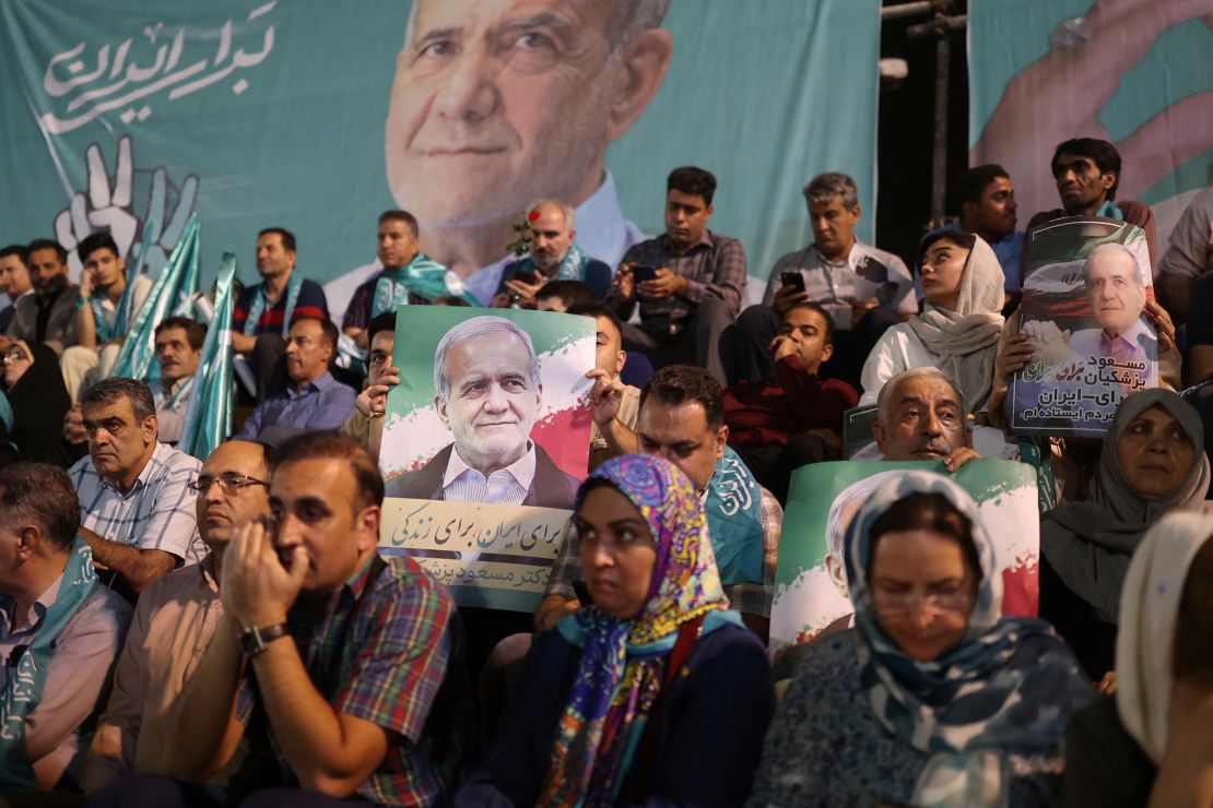 Supporters hold posters of Iranian presidential candidate Masoud Pezeshkian during a campaign event in Tehran, Iran, on July 3.