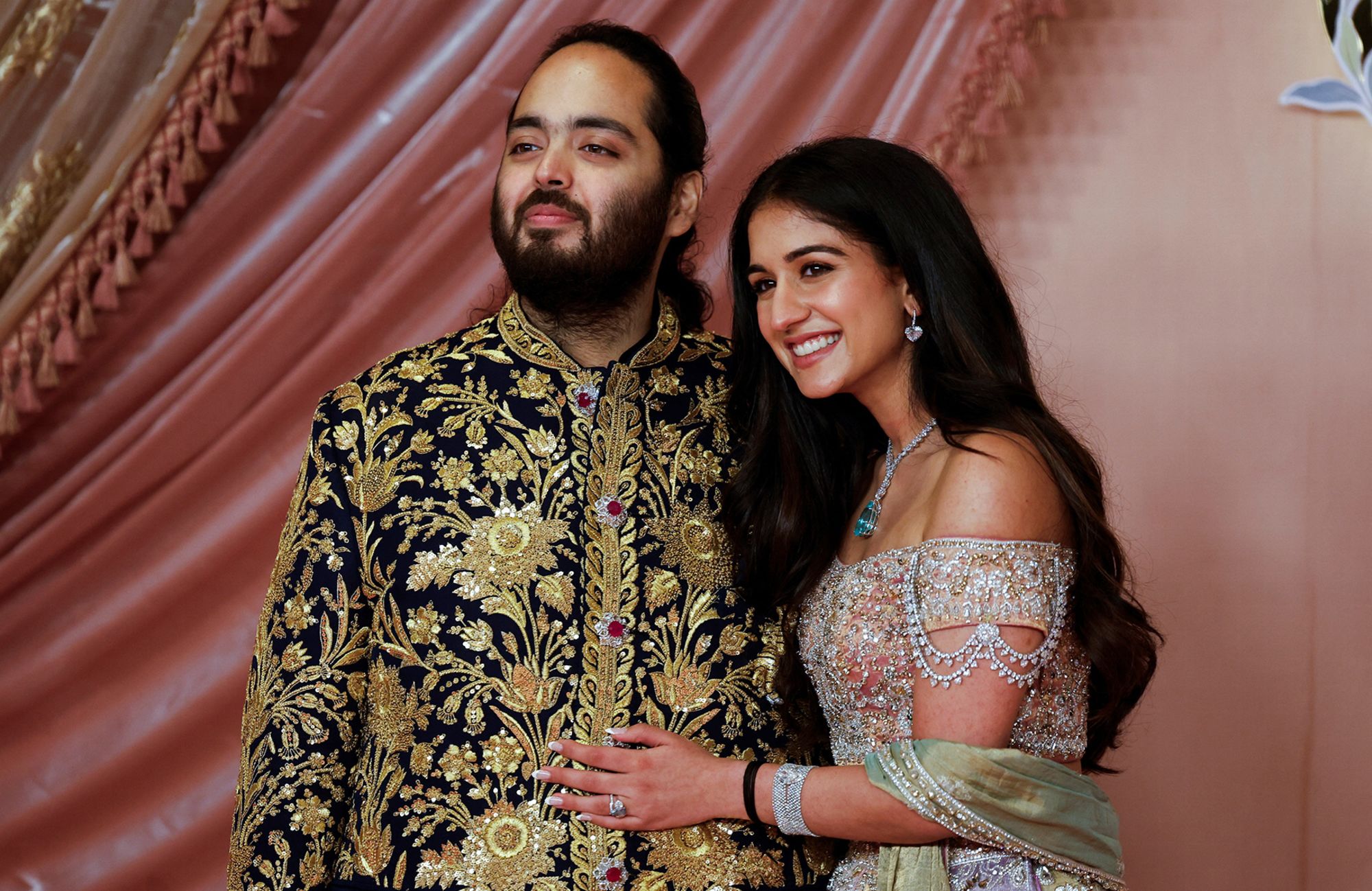 Anant Ambani, son of businessman Mukesh Ambani, poses with his fiancee Radhika Merchant during their sangeet ceremony in Mumbai, India, on Friday.