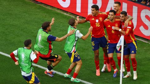 Spain's Mikel Merino celebrates with teammates after scoring the quarterfinal winner against Germany.