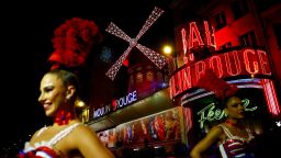 French Cancan dancers perform in front of the Moulin Rouge cabaret to inaugurate the new sails installed atop its iconic windmill, after the original ones fell off in April, in Paris, France, on July 5, 2024.