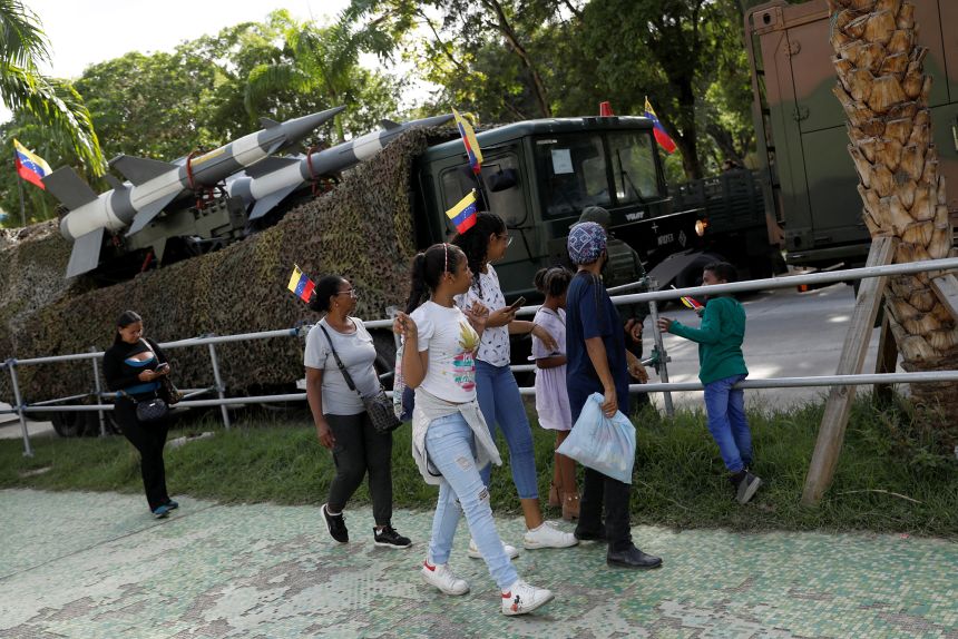 People walk near the Russian S-125 Neva/Pechola surface-to-air missile system during a military parade held as part of the 213rd anniversary of independence from Spain in Caracas, Venezuela, July 5, 2024.