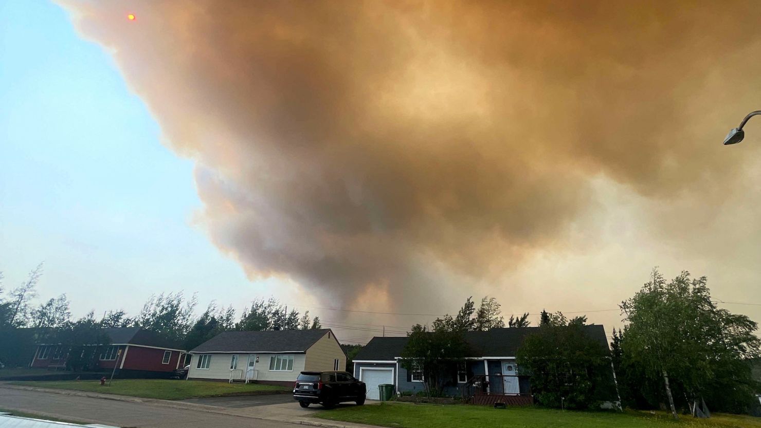 Smoke from an encroaching wildfire is seen over homes after an evacuation was ordered in the eastern Canadian community of Labrador City, Newfoundland, Canada, on Friday.