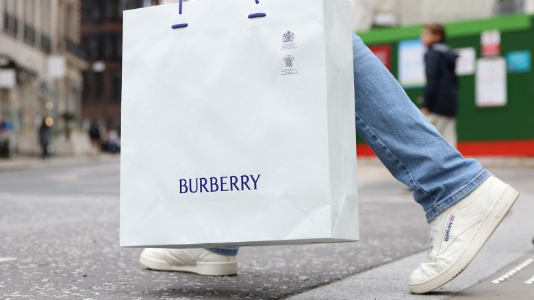 A man carries a Burberry shopping bag on New Bond Street in London, Britain, July 15, 2024.