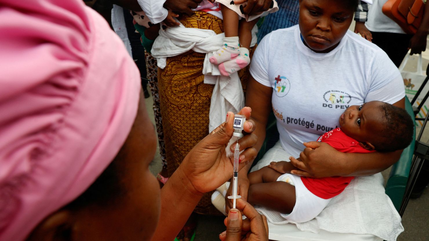 A health employee prepares to give a malaria injection to a child during the official ceremony for the launch of a malaria vaccination campaign in Ivory Coast.