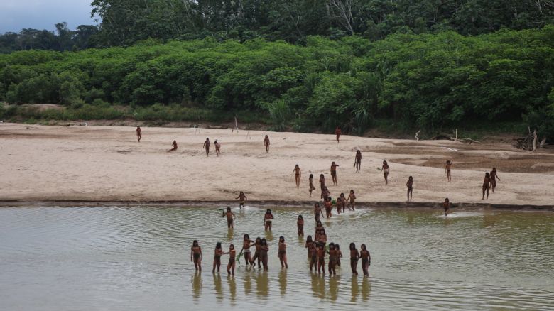 Members of the Mashco Piro Indigenous community, a reclusive tribe and one of the world's most withdrawn, gather on the banks of the Las Piedras river where they have been sighted coming out of the rainforest more frequently in search of food and moving away from the growing presence of loggers, in Monte Salvado, in the Madre de Dios province, Peru, June 27, 2024. Survival International/Handout via REUTERS ATTENTION EDITORS - THIS IMAGE HAS BEEN SUPPLIED BY A THIRD PARTY NO RESALES. NO ARCHIVES
 
 