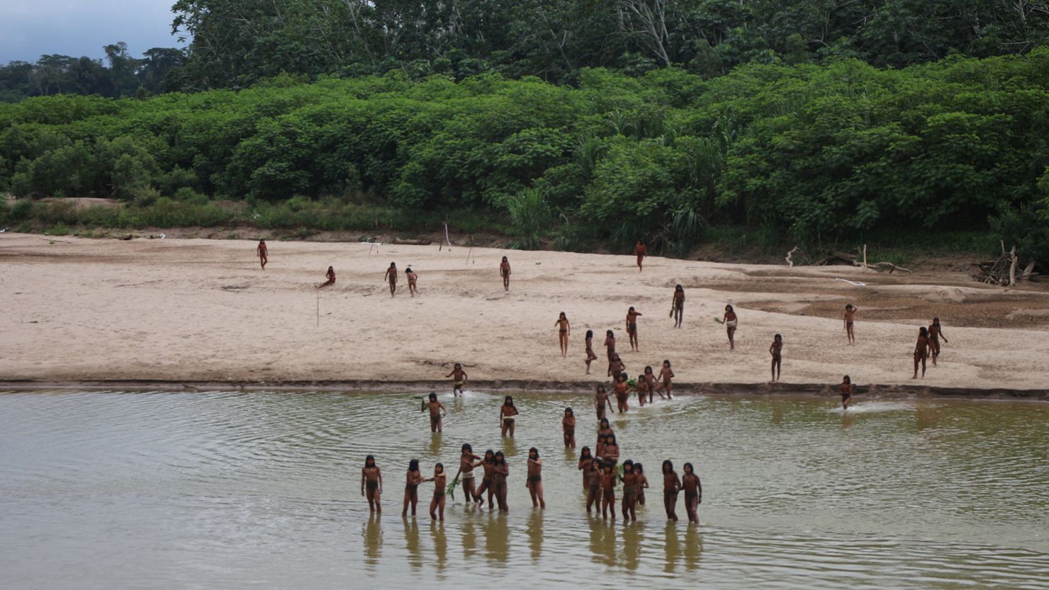 Members of the Mashco Piro Indigenous community gather on the banks of the Las Piedras river in Monte Salvado, in the Madre de Dios province of Peru, on June 27, 2024.