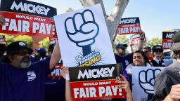 Workers gather with signs as the Teamsters union and Disney cast members demand fair wages at a rally outside Disneyland, in Anaheim, California, U.S., July 17, 2024.