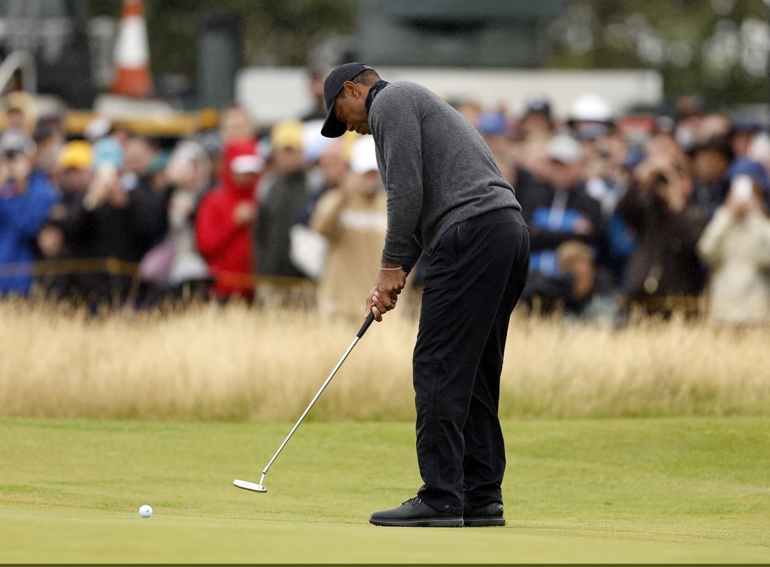 Woods putts on the second green during the first round.