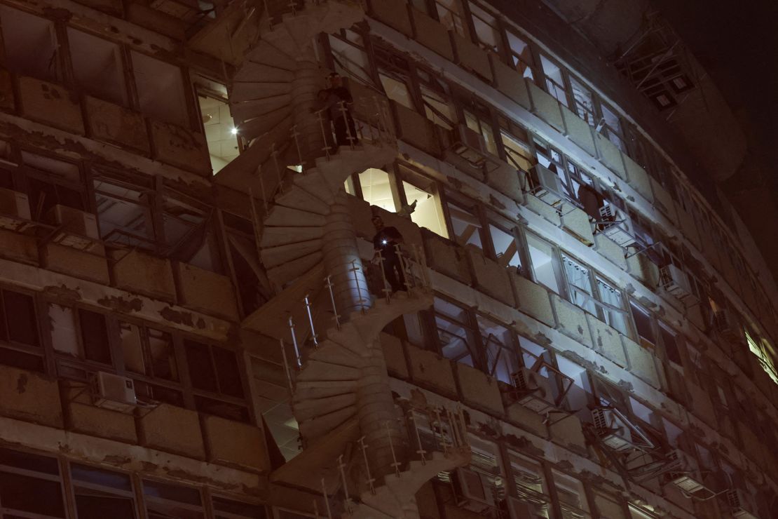 A person walks down the stairs of a building damaged by a blast in Tel Aviv on July 19, 2024.