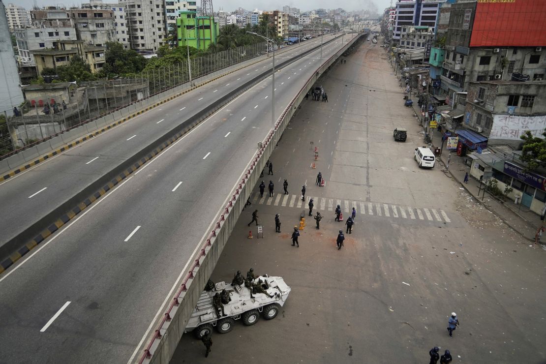 Members of the Bangladesh Army sit on an armoured vehicle along with police during a curfew imposed in response to student-led protests against government job quotas in Dhaka on Saturday.