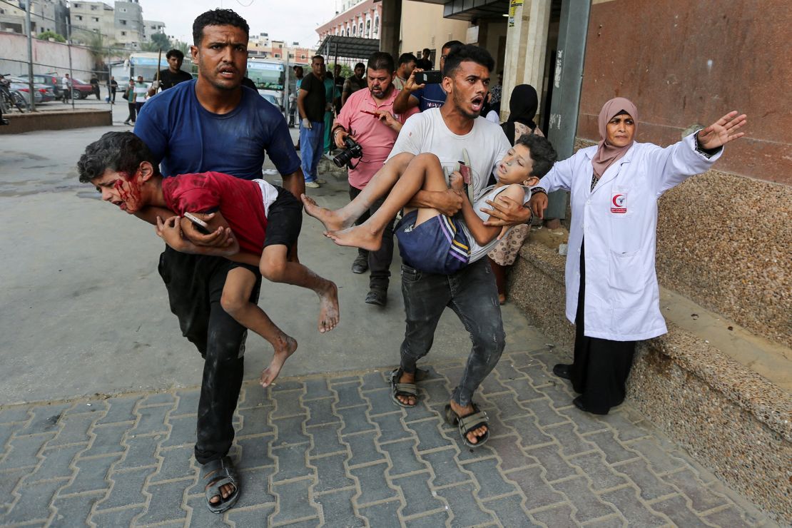 Palestinians carry children wounded by an Israeli strike, at Nasser hospital, on July 22. People displaced in Khan Younis expressed anger at Israel, Hamas and other Arab leaders for the war.