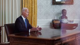 U.S. President Joe Biden is seen through a window as he delivers an address to the nation on his decision to end his reelection campaign, from the Oval Office of the White House in Washington, U.S., July 24, 2024.