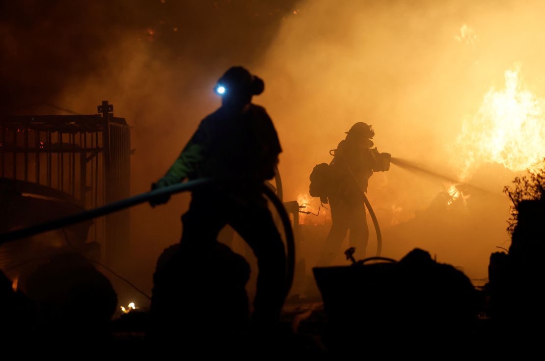 Firefighters work as the Park Fire burns near Chico, California, on July 25.