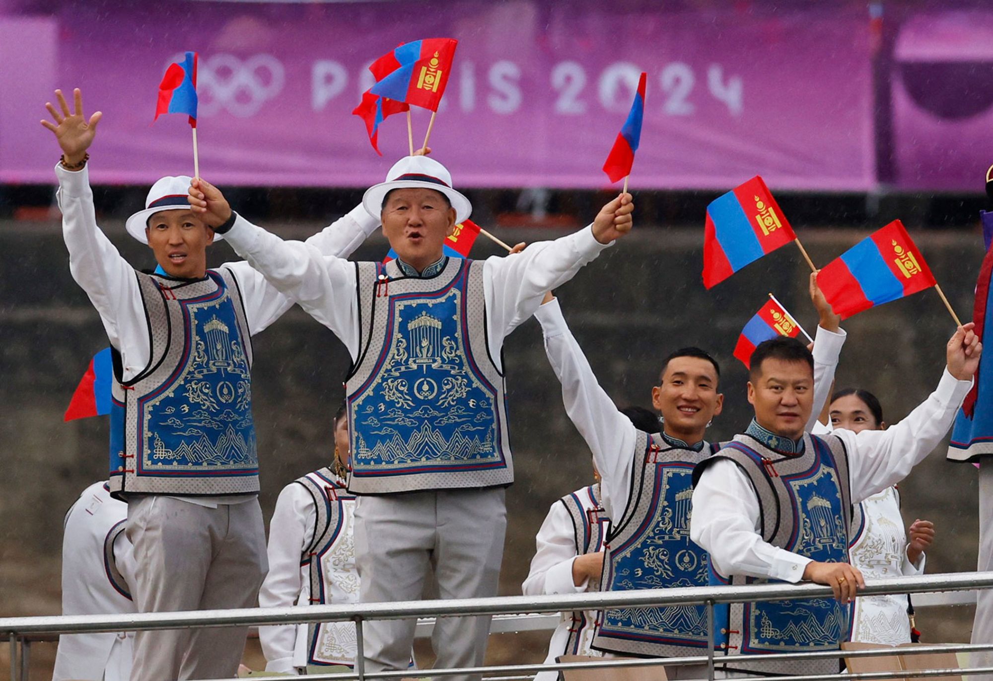 Team Mongolia waves from a boat in the floating parade on the river Seine during the Paris 2024 Olympics opening ceremony on July 26, 2024.