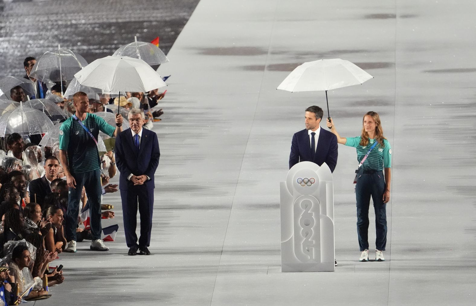 Tony Estanguet, president of the Paris organizing committee, speaks during the opening ceremony. On the left is Thomas Bach, president of the International Olympic Committee.