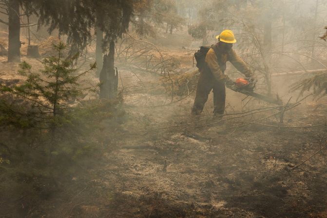 A contract wildland firefighter from AFS Forestry uses a chainsaw during the Battle Mountain Complex Fire in Grant County, Oregon, on July 26, 2024.