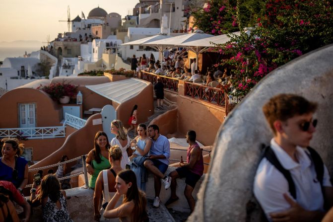 <strong>Santorini: </strong>In this photo from July 25, tourists wait on the Greek island of Santorini to see the world-famous sunset.