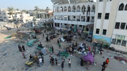 Palestinians inspect a destroyed school building, following an Israeli strike, amid Israel-Hamas conflict, in Deir Al-Balah, in the central Gaza Strip, July 27, 2024. REUTERS/Ramadan Abed