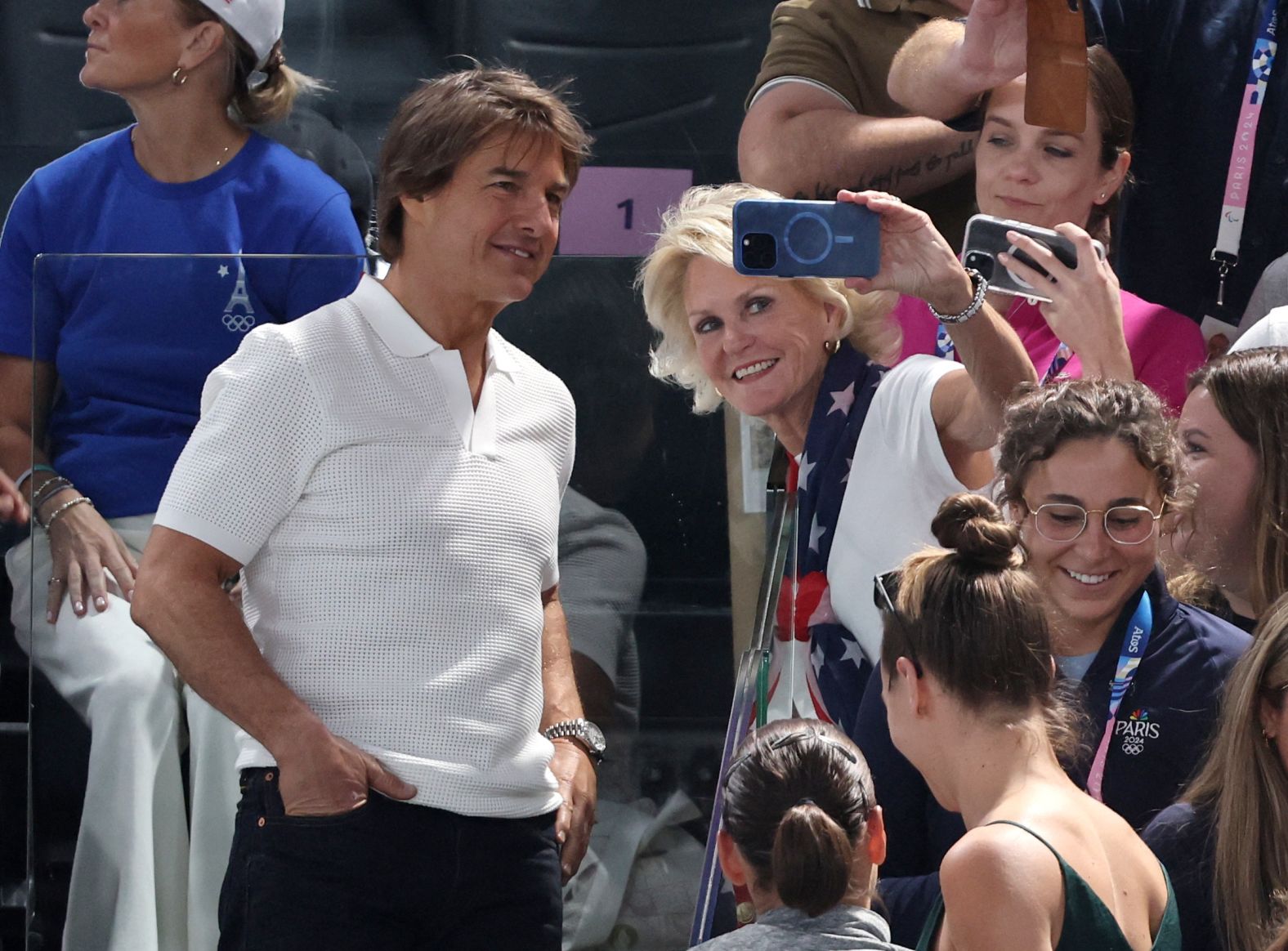 Actor Tom Cruise takes a photo with a fan during the women's gymnastics qualification round on July 28. <a >Other celebrities watching</a> included Snoop Dogg and Ariana Grande.