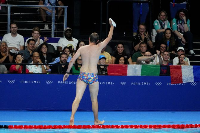 The crowd cheers for a lifeguard after he went into the pool to recover the swim cap of US swimmer Emma Weber on July 28. Lifeguards like this are common at swimming competitions, but it still provided a moment of levity in between races. <a >NBC's commentary crew deemed him “Bob the Cap Catcher.”</a> The lifeguard declined to release his name, a Paris 2024 spokesperson said, so that he could keep the focus on his duties.