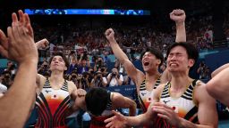 Paris 2024 Olympics - Artistic Gymnastics - Men's Team Final - Bercy Arena, Paris, France - July 29, 2024. Daiki Hashimoto, Kazuma Kaya, and Takaaki Sugino of Japan celebrate. REUTERS/Amanda Perobelli