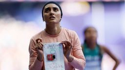 Kimia Yousofi of Afghanistan holds up a sign after competing in the women’s 100m preliminaries in Saint-Denis, France, on August 2, 2024.