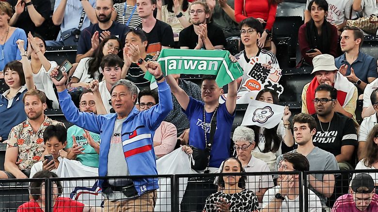 Paris 2024 Olympics - Badminton - Men's Doubles Semifinals - Porte de La Chapelle Arena, Paris, France - August 02, 2024. A supporter holds a towel referencing Taiwan during a badminton match.