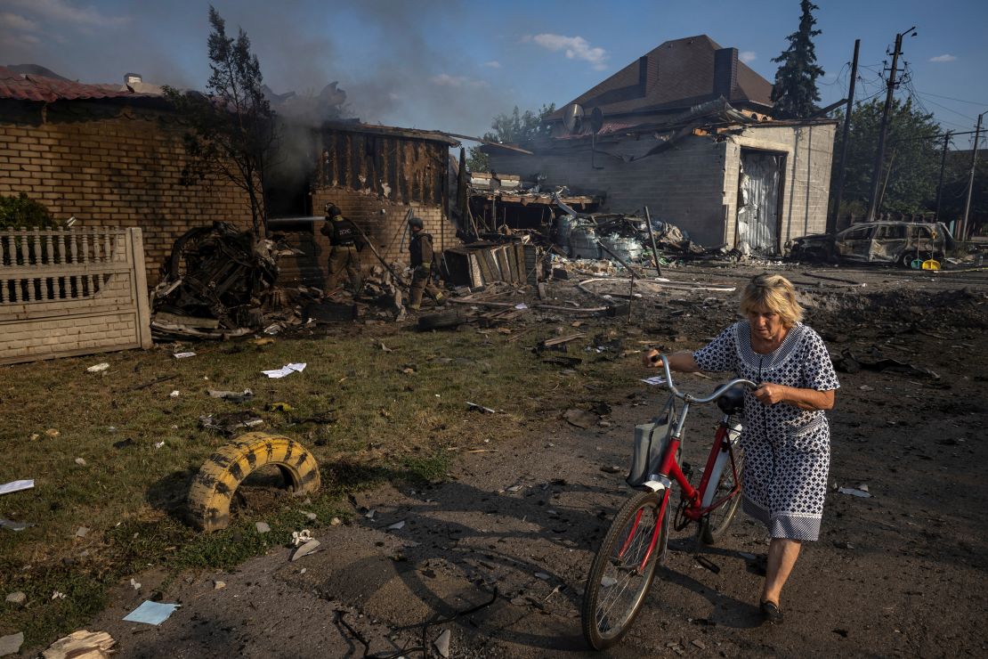 A woman walks past a house that was destroyed after a Russian strike on a residential area in Pokrovsk on August 3.