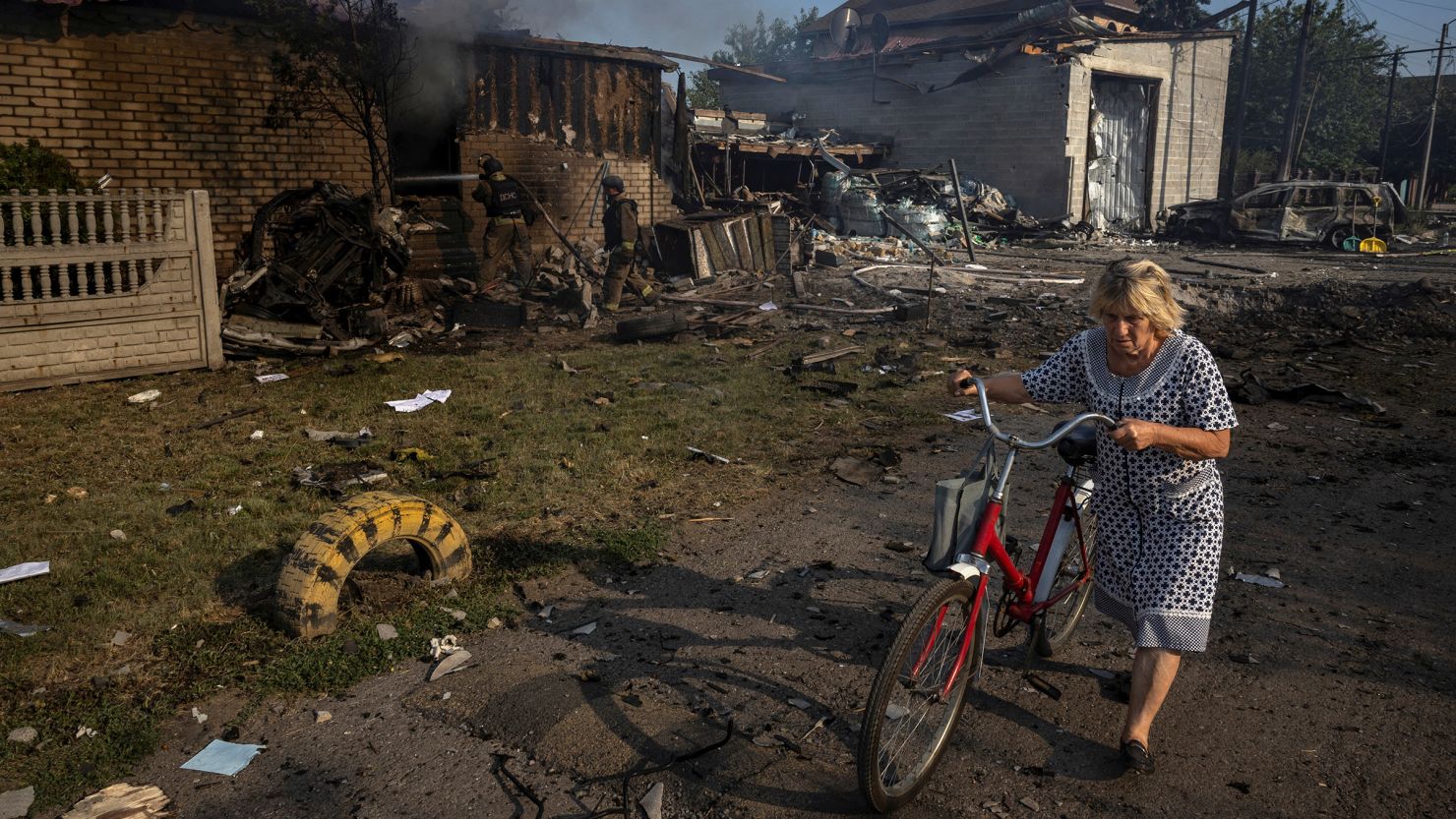 A woman walks past a house that was destroyed after a Russian strike on a residential area in Pokrovsk, Ukraine, on August 3, 2024.