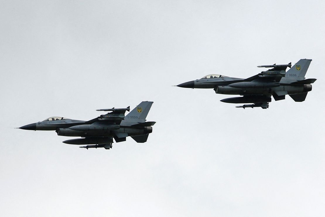 Ukrainian F-16 fighting aircrafts are seen in the air during marking the Day of the Ukrainian Air Forces, in an undisclosed location, Ukraine, August 4, 2024.